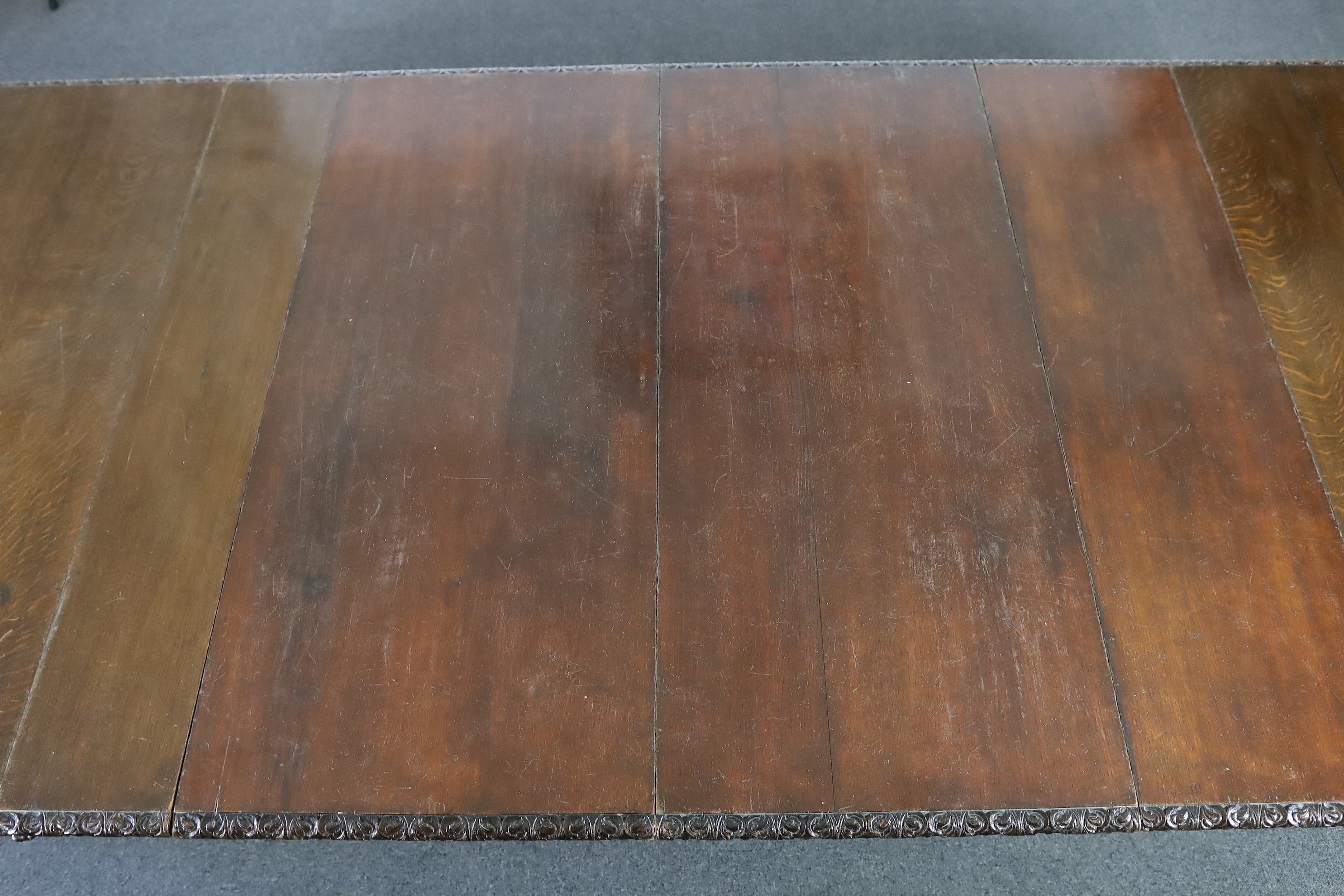 A late Victorian carved oak extending dining table, 178 x 142cm, extends to 356cm H.75cm